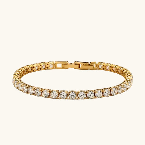 A gold tennis bracelet featuring a continuous row of round-cut clear gemstones