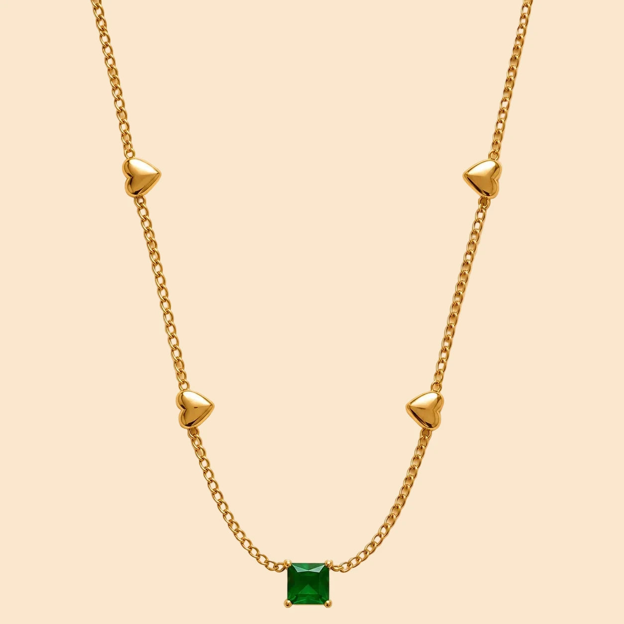 Gold necklace with a green gemstone
