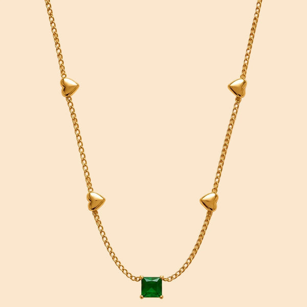 Gold necklace with a green gemstone