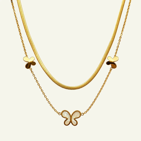 Two gold necklaces with butterfly pendants 