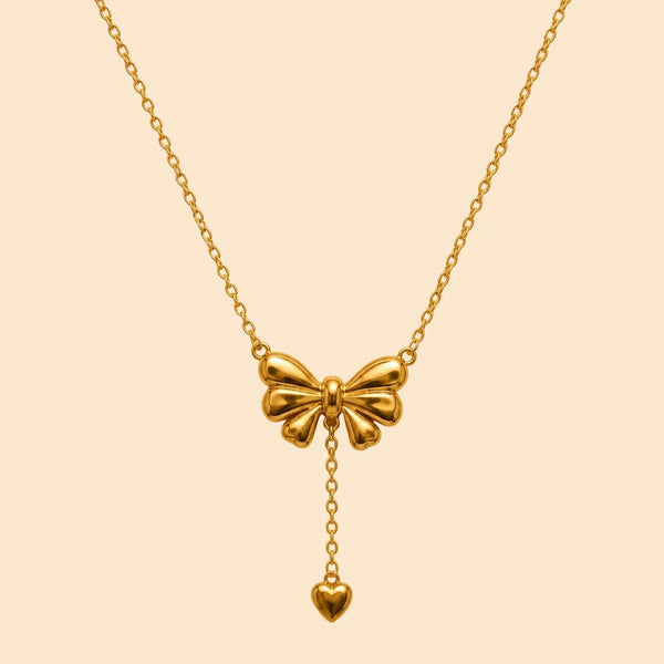 Gold bow-shaped necklace with a heart pendant 