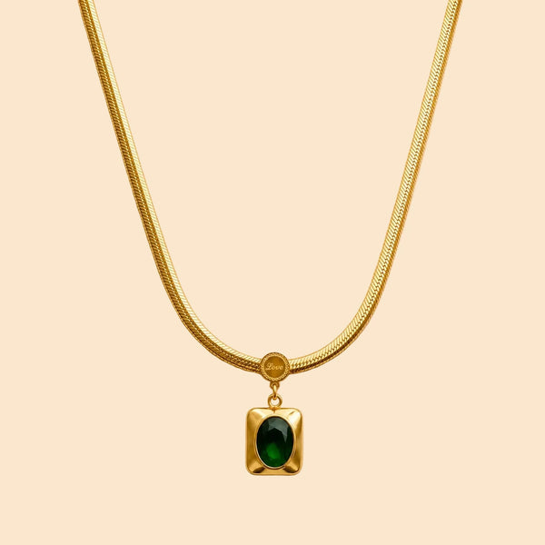 Gold necklace with a green emerald stone pendant